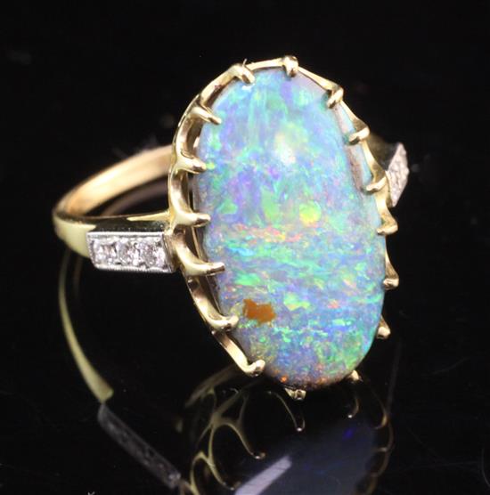 An 18ct gold and white opal ring with round brilliant cut diamond set shoulders, size P.